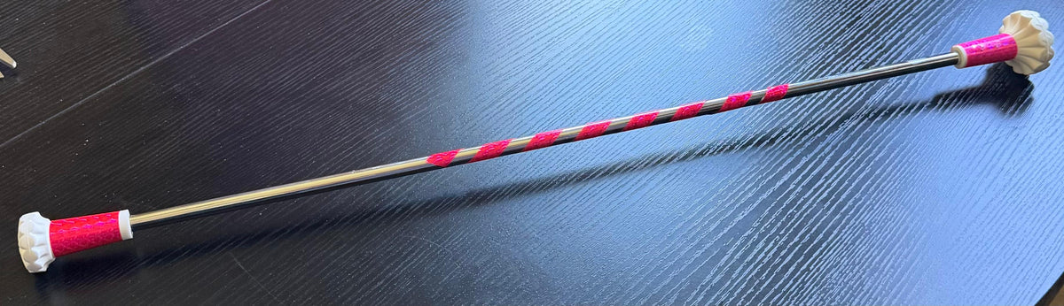 Twirling baton with pink spiral grip tape and pink accents.