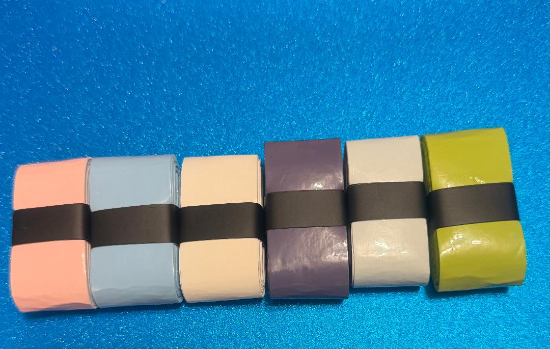 Six colored baton grips with black bands on a blue background