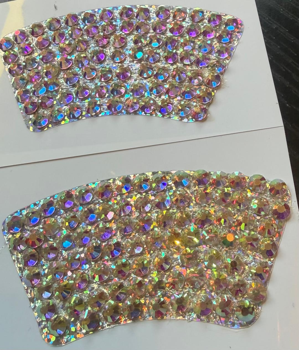 Close-up of two rhinestone-covered curved halo designs
